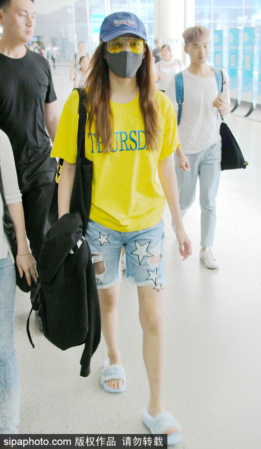 關曉彤黃T短褲踩拖鞋現身上海機場 獲眾人護駕見鏡頭比V賣萌